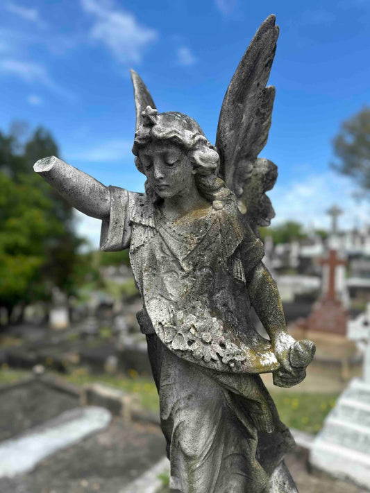 statue of an angel at a graveyard